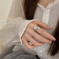 Mother-of-Pearl Clover Pearl Open Ring A delicate adjustable ring with soft pearl shine and a romantic four-leaf floral design.